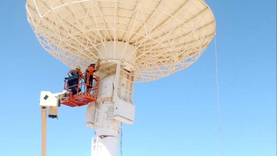 Workers maintaining satellite